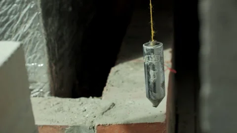 Builder Using Plumb Bob to Align Brick Wall Video stock 317380463
