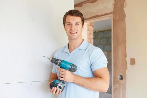 Builder Using Power Tool On Site Stock Photos