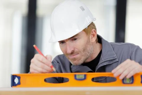 A builder using spirit level Stock Photos