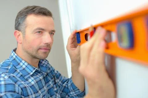 Builder using a spirit level Stock Photos