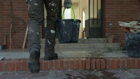 Builder Walking with Bucket Full of Water Stock Footage 145389413