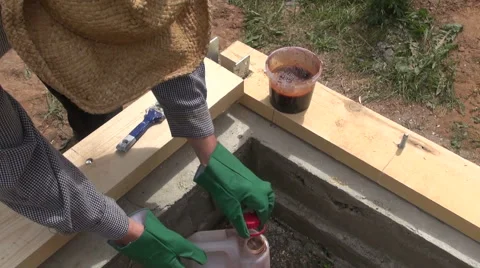 Builder waterproofing wooden plank Stock Footage 64986427
