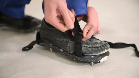 Builder wears shoes with spikes Video stock 73390495