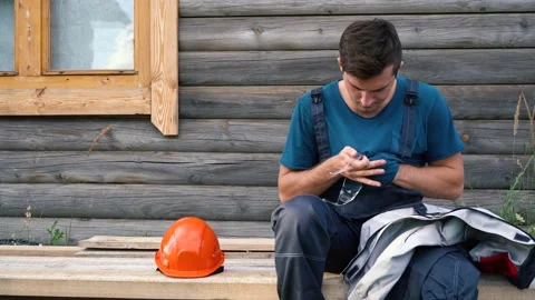 Builder wipes and then puts on the glasses Stock Footage 156733564