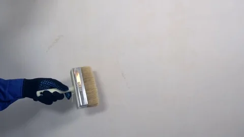 The builder wipes wall of dust Video stock 73099445