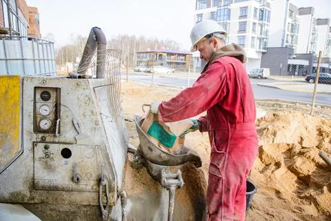 A builder in work clothes is doing his job Stock Photos