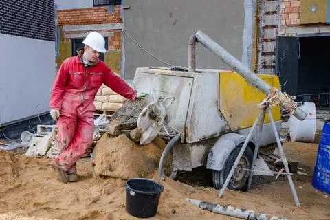 A builder in work clothes is doing his job Foto stock