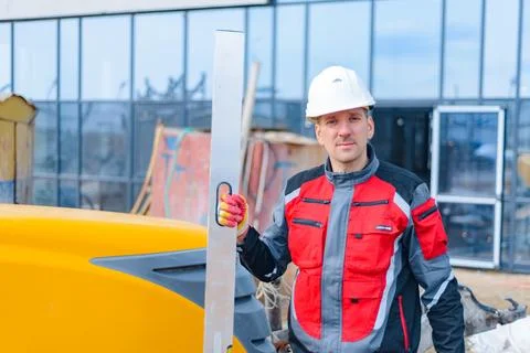 A builder in work clothes is doing his job Stock Photos