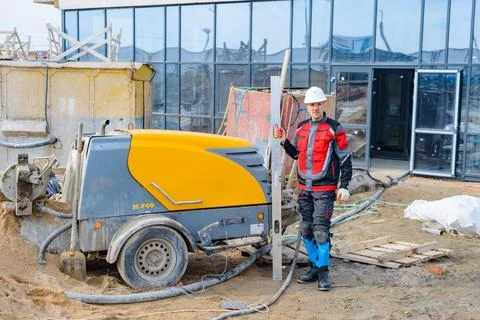 A builder in work clothes is doing his job Stock Photos