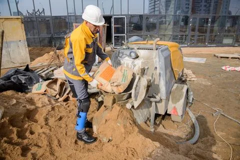 A builder in work clothes is doing his job Stock Photos