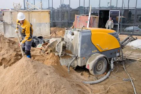A builder in work clothes is doing his job Stock Photos