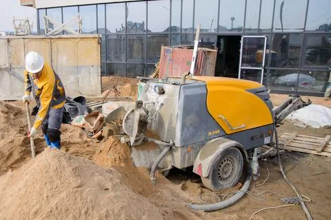 A builder in work clothes is doing his job Stock Photos