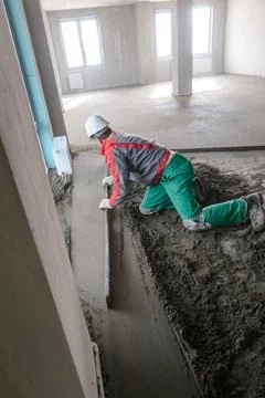 A builder in work clothes is doing his job Stock Photos