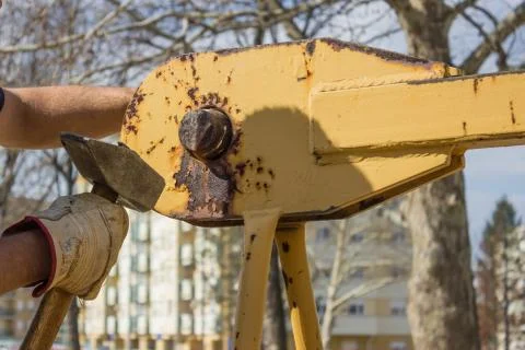 Builder worker with hammer installing part of crane construction Stock Photos