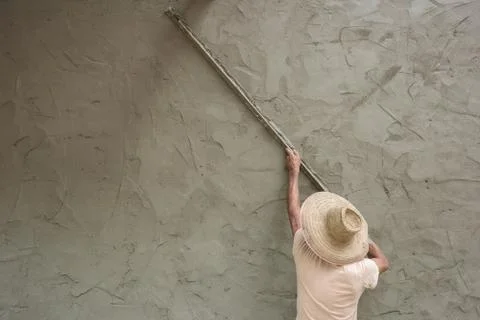 Builder worker plastering  concrete at wall Stock Photos