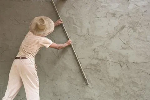 Builder worker plastering  concrete at wall Stock Photos