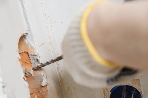 Builder worker pneumatic hammer drills hole in concrete brick wall with diamond Stock Photos