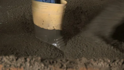 Builder worker pouring concrete into form Stock Footage 98761926