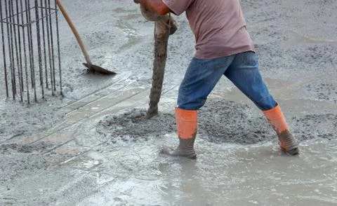 Builder worker with tube pump cement Stock Photos