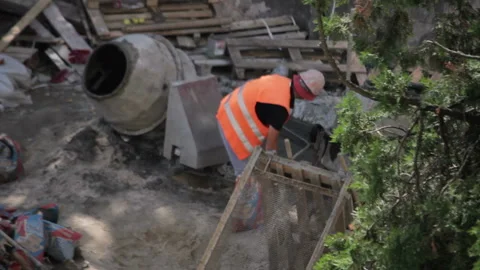Builder working with concrete mixer and prepares cement mortar Stock Footage 113497219