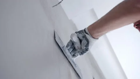 Builder working on construction site, man in protective working gloves levelling Stock-Footage 163442663