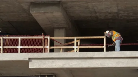 Builder working on a floor of a building. Stock-Footage 147995131
