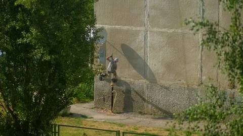 Builder working at height while holding on a rope and insurance. Stock Footage 245103223