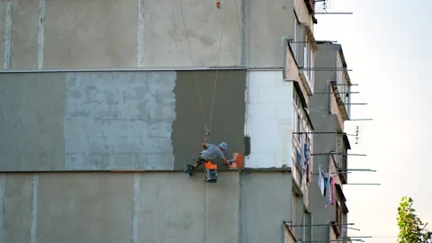 Builder working at height while holding on a rope and insurance. Video stock 245103509
