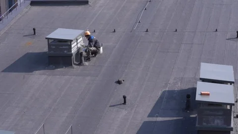 Builder working on the roof of a building Stock Footage 106277314