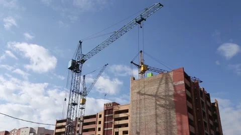 Builder works at against background of the construction site high-rise buildings Stock Footage 62475371