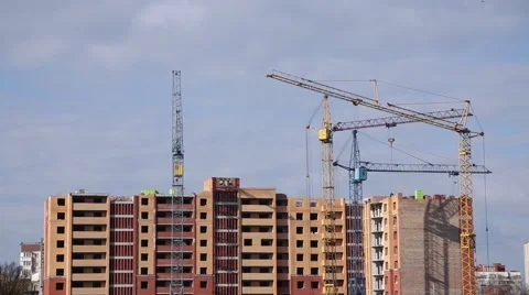 Builder works at against background of the construction site high-rise buildings Stock Footage 62475560