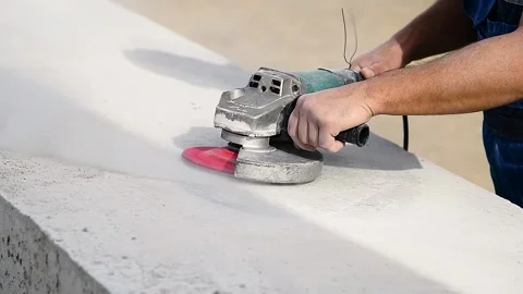 The builder works with an angle grinder Видео 222586733