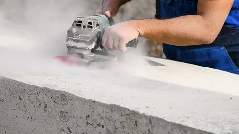 The builder works with an angle grinder Stock Footage 223688948