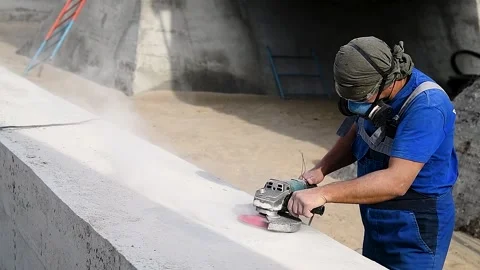 The builder works with an angle grinder 動画素材 223688970