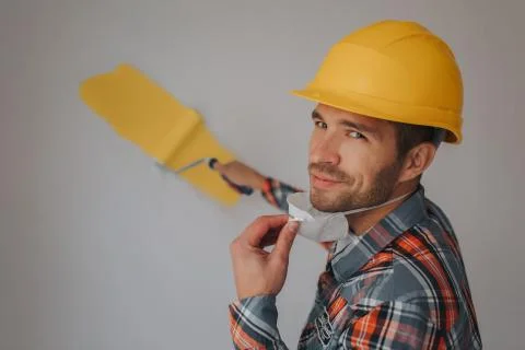 The builder works at the construction site and measures the ceiling. A worker Stock Photos
