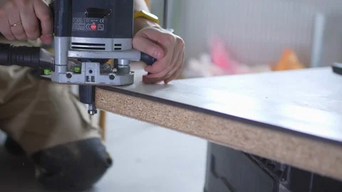 The Builder works with an electric cutter 스톡 동영상 103950526
