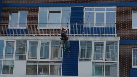 Builder works at height in multi-apartment modern house Stock Footage 198874420