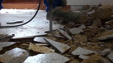 The builder works with a pneumatic hammer Stock Footage 120055930