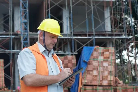 Builder in yellow helmet Stock Photos
