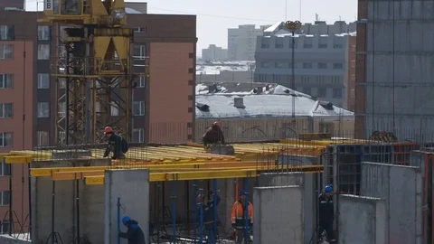 Builders and crane working on Unfinished Residential Building Construction Site Stock Footage 98739923