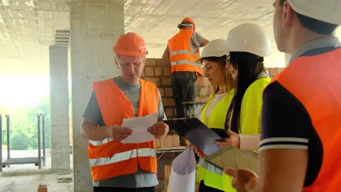 Builders and engineers make decisions regarding project stages Stock Footage 317614845