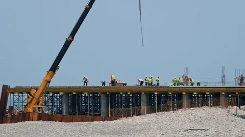 Builders and workers at construction site on sea pier on coastline Video stock 276644682