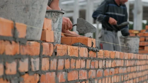Builders are building a brick wall Video stock 235715786