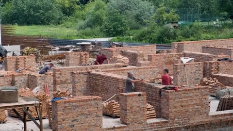 Builders are building a brick wall Video stock 245569685