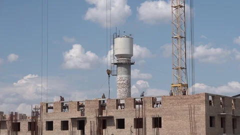 Builders are building a house, put a brick on the roof Stock Footage 129792066