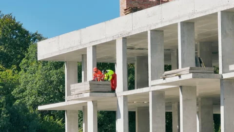 Builders are unpacking a large cargo during the construction of a house Stock Footage 211729946