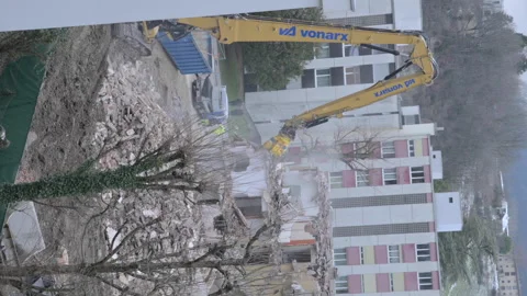 Builders break down an old multi-storey residential building. Construction Stock Footage 244747357