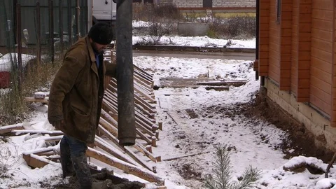 Builders build concrete retaining wall in formwork on country land plot Stock Footage 83504332