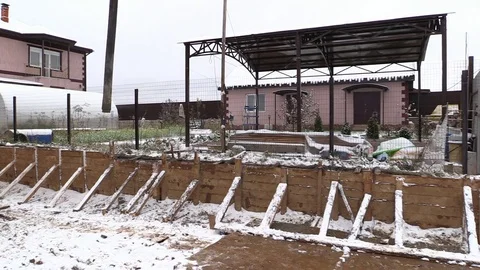 Builders build concrete retaining wall in formwork on country land plot Stock Footage 83504351