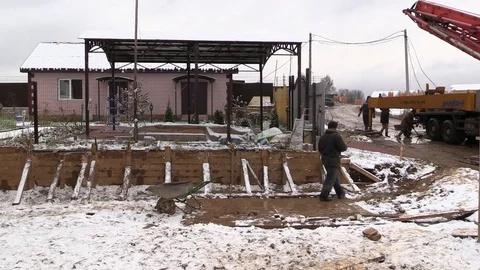 Builders build concrete retaining wall in formwork on country land plot Stock Footage 83504376